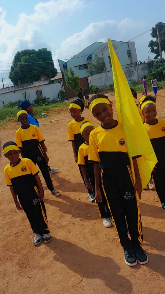 Sports Day — Yellow team marching with flag